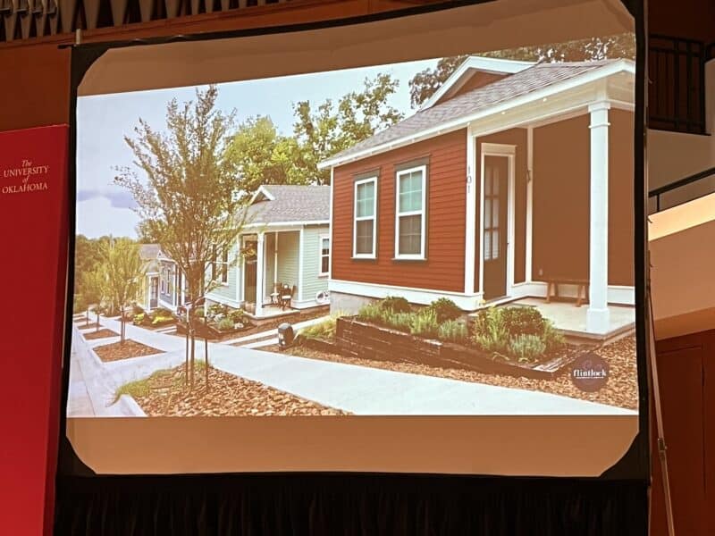 Photo by Becky McCray. Slide by Allison Thurmond Quinlan, Principal of Flintlock Labs Photo of a row of small houses on a sloping lot. They have tiny yards with cute flower beds and are painted in attractive colors.