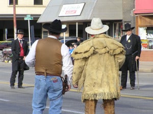 They're historical re-enactors! Not an actual dispute! :) Cowboy re-enactment group the Dog Creek Gunfighters square off for a staged fight in downtown Alva.