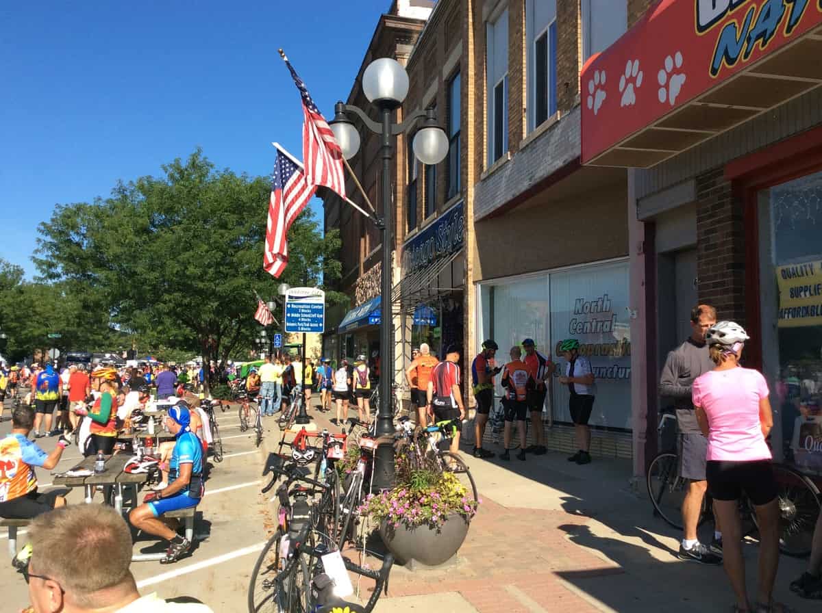 What can a business do when downtown is packed full of people who aren't shopping for what you sell? RAGBRAI cyclists in downtown Webster City, Iowa. Photo by Deb Brown, used by permission.